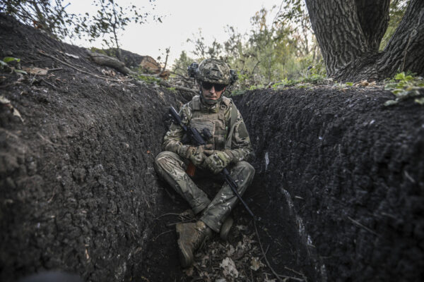 A soldier sits in a trench on the front line near Bakhmut, Ukraine.