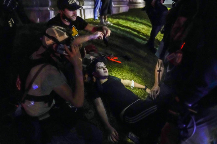 Gaige Grosskreutz tends to injured people during street demonstrations in Kenosha, Wsiconsin