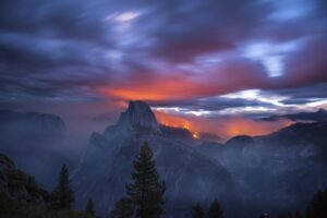 Dawn breaks as the Meadow Fire lights the forest and clouds to the northwest of El Capitan Peak in Yosemite National Park, Calif. 3:13am. 30 seconds with 24mm lens @f.4 