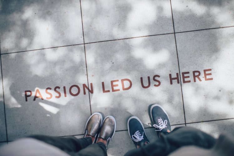 Sidewalk with stamped words PASSION LED US HERE