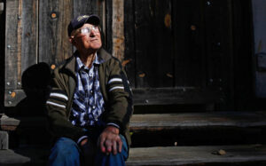 Jack English sits on the steps of his tool shed and work shop. Photo by Barbara Davidson / Los Angeles Times