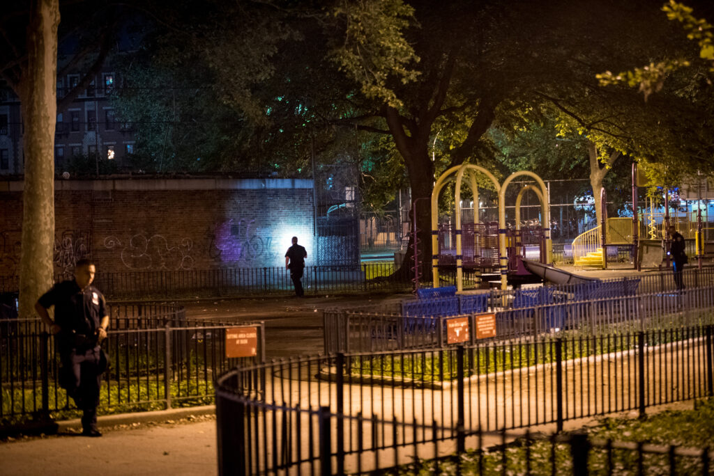 Police investigate the crime scene where Jessica White, 28, mother of 3. was shot in the chest while sitting in a playground. 