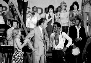 President Richard M. Nixon at a youth rally in Miami Beach, Fla., after the Republican National Convention nominated him for re-election. With him are Pam Powell, head of Young Voters for the President, and Sammy Davis, Jr., the rally master of ceremonies. 