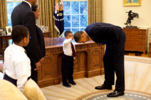 President Obama lets a little boy touch his hair. The boy, a son of a staffer, wanted to know if his hair was just like the president's.