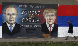 A woman passes by graffiti depicting the Russian President Vladimir Putin and President Elect Donald Trump in a suburb of Belgrade, Serbia. 