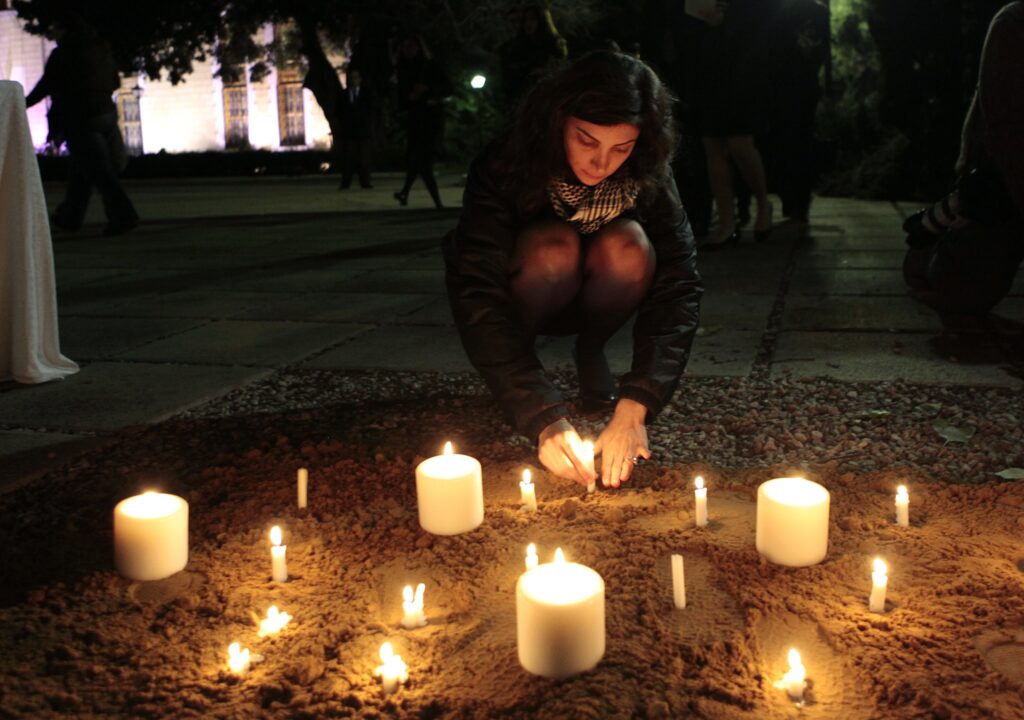 Nada Bakri, Anthony Shadid's widow, lights candles after a memorial ceremony for her husband at the American University of Beirut, Lebanon. 