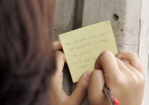 A student at Henry M. Gunn High School writes a message on a school wall after a suicide in 2009. 