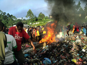 Bystanders watch as a woman accused of witchcraft is burned alive in Papua New Guinea in 2013. Kepari Leniata was stripped naked by several assailants, tortured with a hot iron rod, bound, doused in gasoline, then set alight on a pile of car tires and trash.