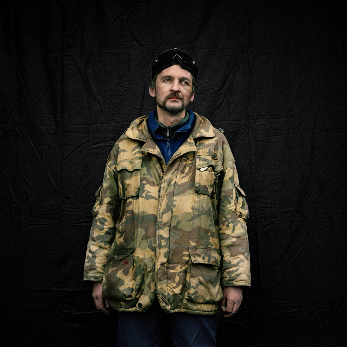 Taylor-Lind photographed Oleg, above, and the other subjects of "Maidan: Portraits from the Black Square" in front the same black backdrop, removing them from the violence of the square