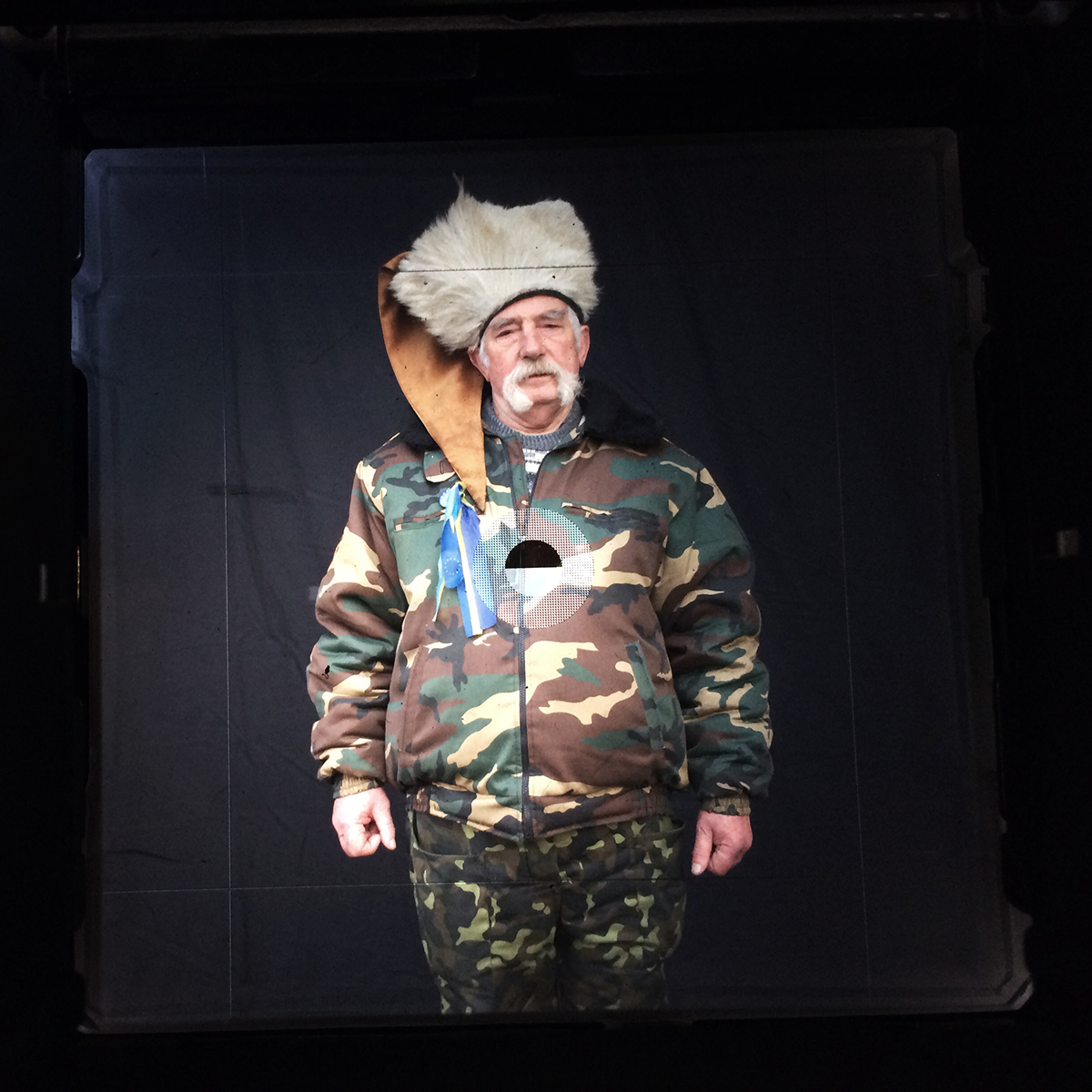 By mounting an iPhone over her viewfinder, Taylor-Lind was able to share the moments before and after photographing Talas, above, for "Maidan: Portraits from the Black Square"
