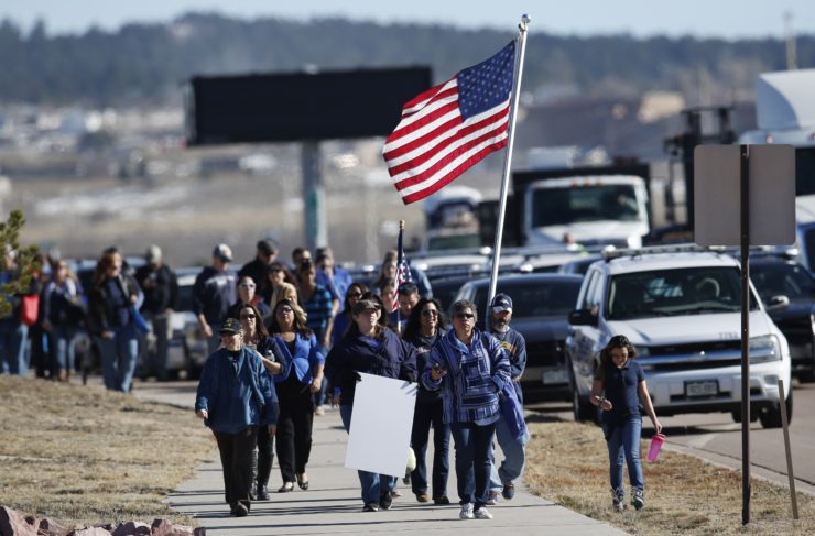Law enforcement supporters wait for the hearse carrying one of the victims of the Colorado Springs Planned Parenthood shooting. 