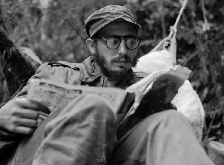 In this 1959 photo, Fidel Castro, then a guerrilla leader, does some reading while at his rebel base in Cuba's Sierra Maestra mountains. 
