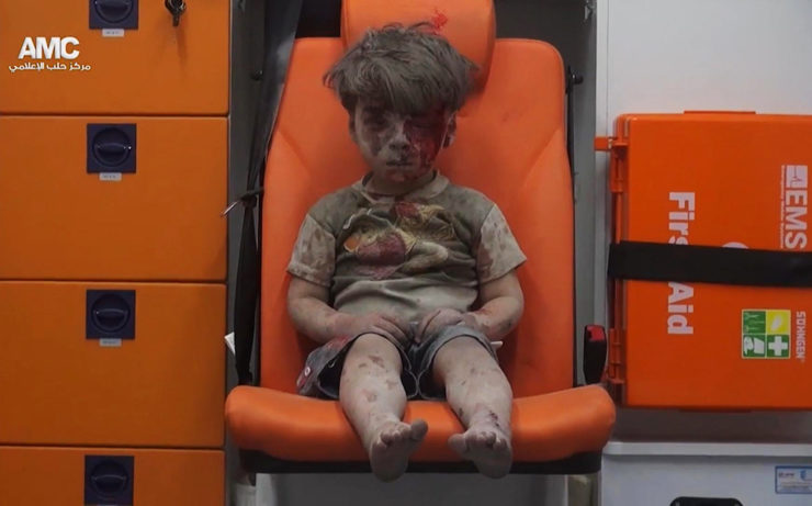 In this frame grab taken from video provided by the Syrian anti-government activist group Aleppo Media Center, 5-year-old Omran Daqneesh sits in an ambulance after being pulled out of a building hit by an airstrike in Aleppo on Aug. 17.