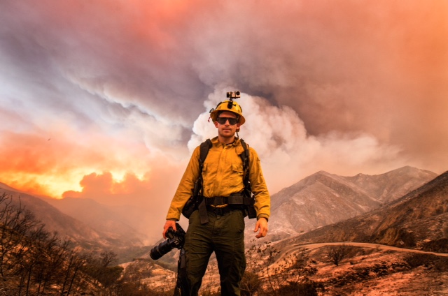 Photojournalist Stuart Palley, dressed in fire-resistant clothing, stands upwind during the Sand Fire on Little Tujunga Canyon Road north of Los Angeles.
