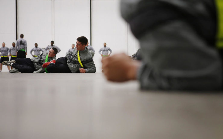 Spc. Jayson Morton, center, stretches during physical training at Ft. Riley, Kan.