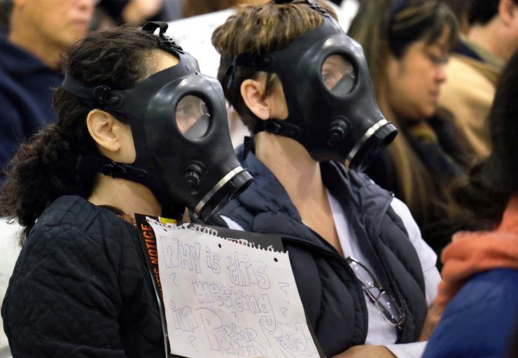 Protesters wearing gas masks attend a hearing over a gas leak near the Porter Ranch community.