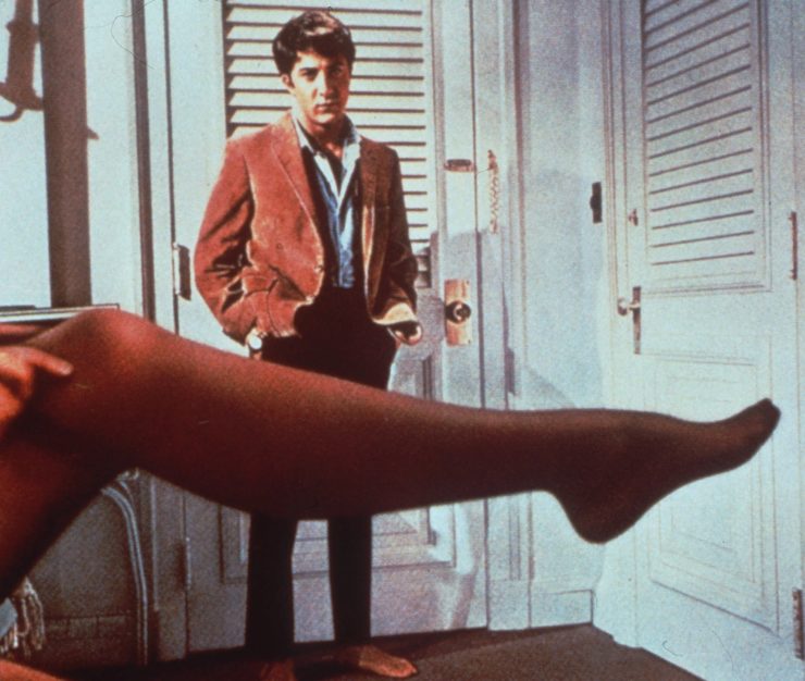 Dustin Hoffman looks over the stockinged leg of actress Anne Bancroft in "The Graduate."