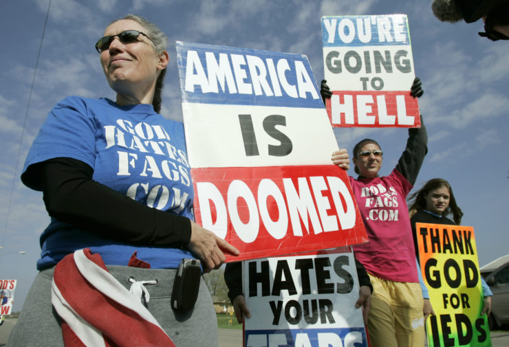 Westboro Baptist Church member Shirley Phelps-Roper, left, holds a protest sign outside funeral services for a serviceman in Iowa in 2006. 