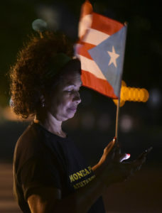 A woman waves a Puerto Rican flag in San Juan after learning that President Obama had commuted the sentence for Puerto Rican nationalist Oscar Lopez Rivera. 