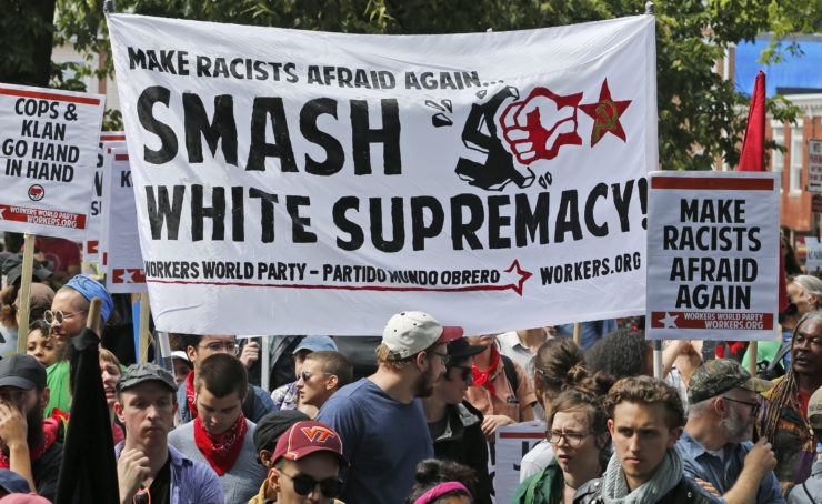 Counter demonstrators holding a banner decrying white supremacists Charlottesville, Va., in August. 