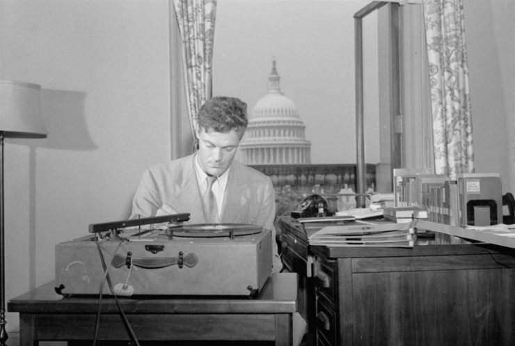 Writer Robert Lowell, Jr., who was the Library of Congress consultant in poetry in English, listens to a playback of a new recording of poetry in his office in Washington in 1948.  