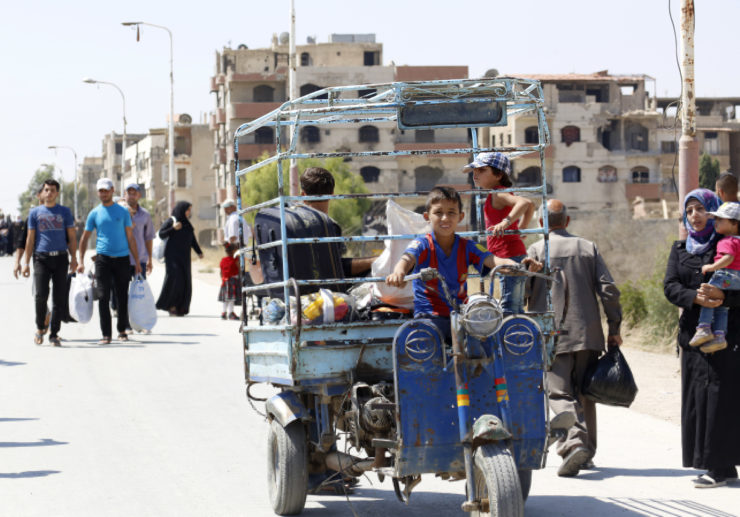 Residents of the Damascus suburb of Darayya, where Enab Baladi was launched, flee in 2016.