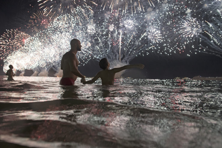 People watch the fireworks exploding over Copacabana beach during New Year's celebrations in Rio  de Janeiro.