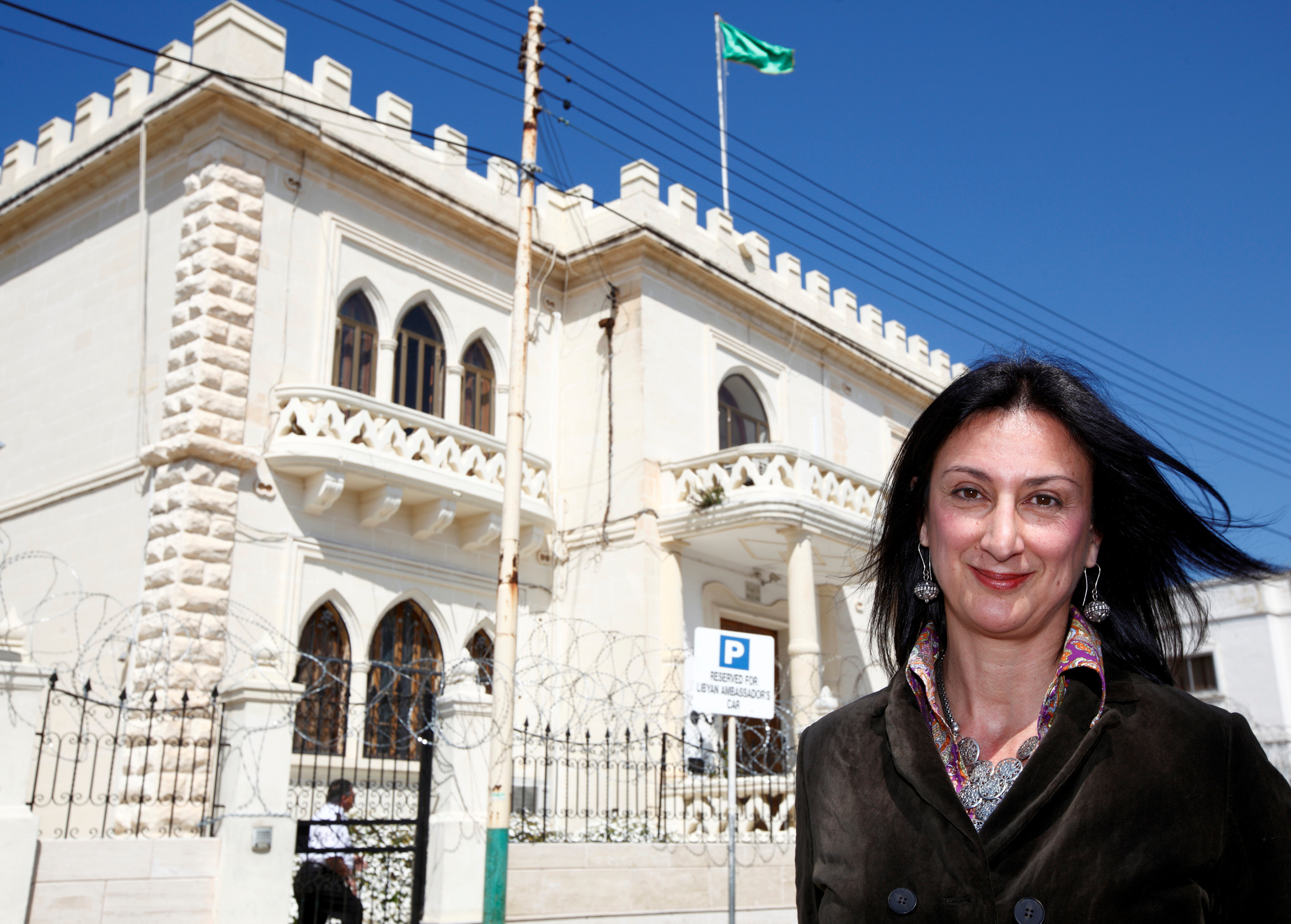 Maltese investigative journalist Daphne Caruana Galizia poses outside the Libyan Embassy in Valletta, Malta, in 2011. The investigative journalist was killed in a car bombing in October 2017