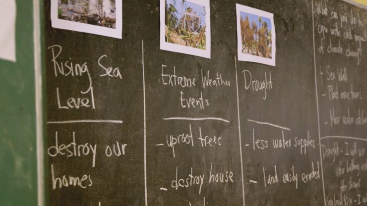 A chalkboard in the Marshall Islands shows some effects of climate change on kids' lives.