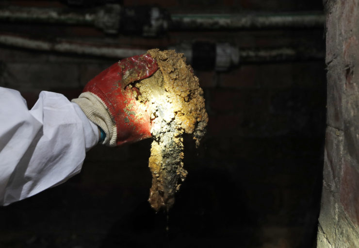 A Thames Water employee holds a piece of the fatberg in an 1852 sewer in London.