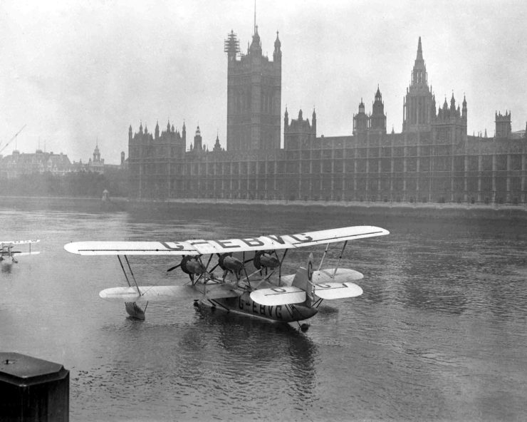 A "flying boat" is moored on the Thames near the Houses of Parliament in 1928.