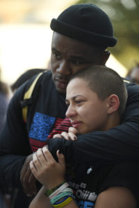 Parkland student activists Jammal Lemy, left, and Emma Gonzalez embrace during an art performance by Manuel Oliver at a peace rally and march, Friday, June 15, 2018, in Chicago. A group of Florida high school shooting survivors started their nationwide bus tour registering young voters to help accomplish their vision for stricter gun laws at the rally on Chicago's South Side.