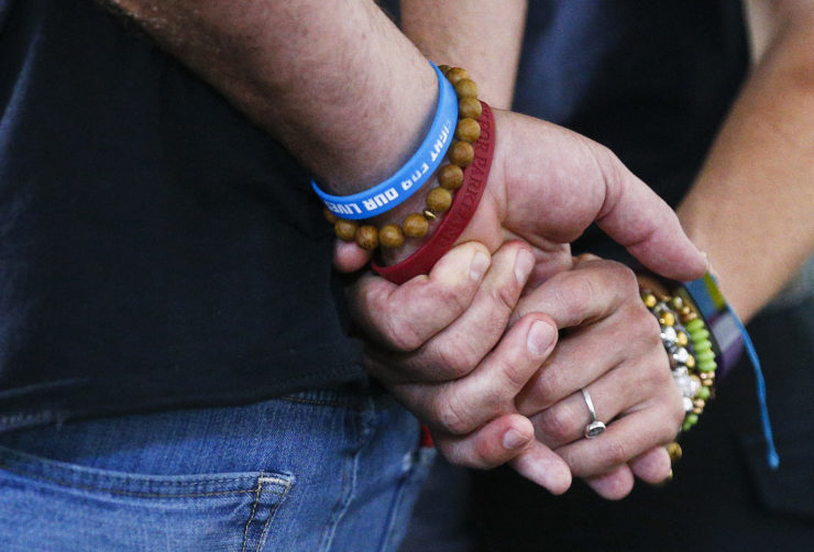 Manuel and Patricia Oliver, parents of Marjory Stoneman Douglas High School shooting victim Joaquin Oliver, hold hands as they speak to the media in Miami during a June 5, 2018, news conference reacting to former sheriff's deputy Scot Peterson interview airing on NBC's "Today Show".