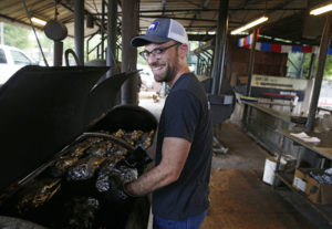 Brendan Meyer gets the feel of a finished brisket at Snow's BBQ in Lexington, Texas