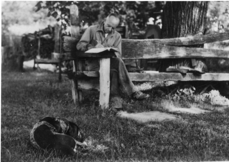 Aldo Leopold writing at his farm near the Wisconsin River sometime in the 1930s. The Leopold family's tree planting helped restore an area that had been ecologically overtaxed by earlier generations. The area served as a setting and inspiration for many of the essays in "A Sand County Almanac."