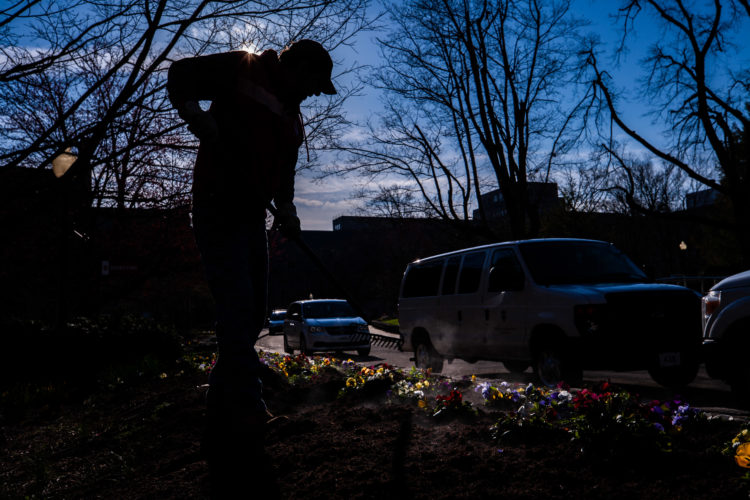 Bruce Cabanaw, who has been on the landscaping crew at Indiana University for 35 years, spreads mulch around on flowerbeds outside the Indiana Memorial Union in early April when Emily Miles wrote about that fickle spring day.