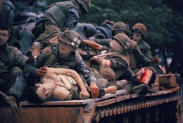 John Olson's iconic photo of a wounded Marine, taken in mid-February 1968 during the infamous Tet Offensive, inspired books, a Newseum exhibit, news stories, and some controversy over the identify of the young American on the stretcher