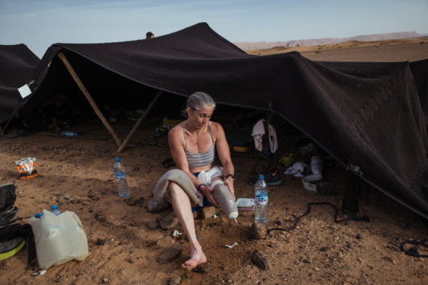 Amy Palmiero-Winters washes her foot after finishing day three of the Marathon des Sables, a 140-mile, six day ultramarathon through the Sahara Desert in Morocco.