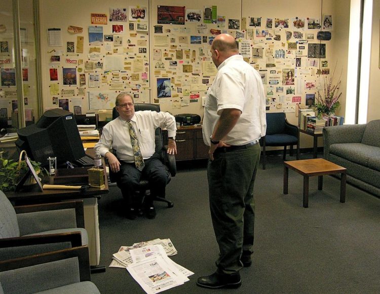 Former Charlotte Observer managing editor Frank Barrows talks with former writer Jeff Elder in his office in 2005.