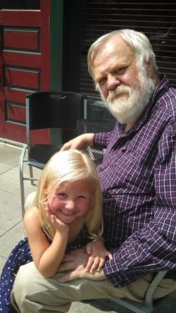 Chuck Haga with his camping partner and story muse, granddaughter Emma. Haga says they have both aged since this picture was taken, but that Emma wears it better.