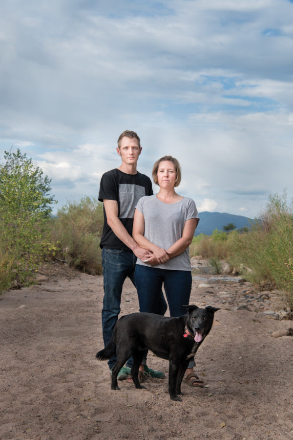 Cally Carswell with her husband, Colin Dyck, and their dog, Google, in a driver riverbed near their home in Santa Fe, New Mexico.