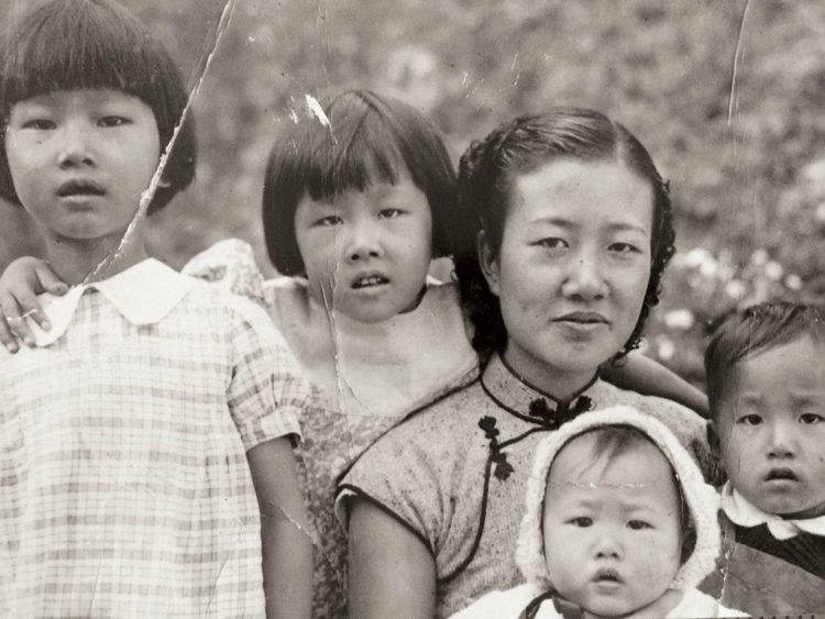 Tom Huang's grandmother with her four children in about 1939, in a passport photo taken at the China-Vietnam border. Huang's mother is second from left.