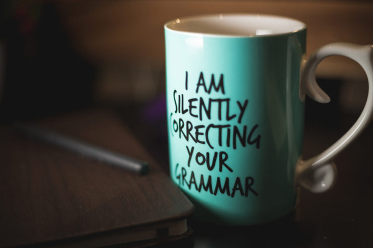 A coffee mug with the words that read: I am silently correcting your grammar.