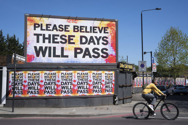 Billboard in London saying "Please Believe These Days Will Pass"