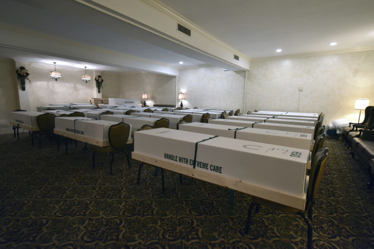 A funeral home in Queens, New York, holds rows of caskets waiting to be shipped for cremation