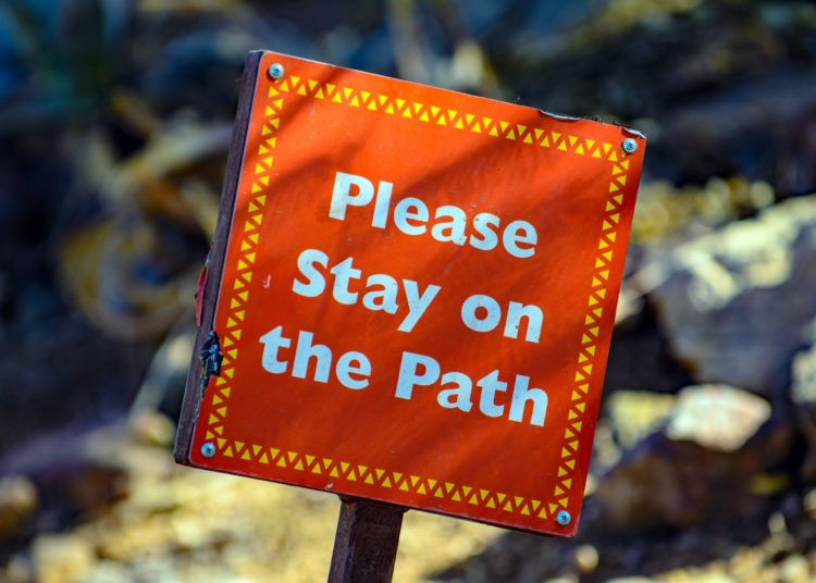"Follow the path" sign