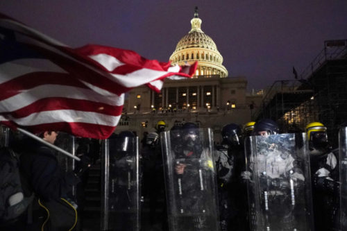 Police guard the U.S. Capitol a day after the Jan. 6 riots