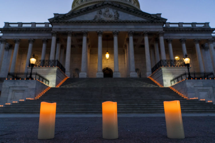Candles up the steps of the U.S. Capitol as COVID deaths hit 500,000
