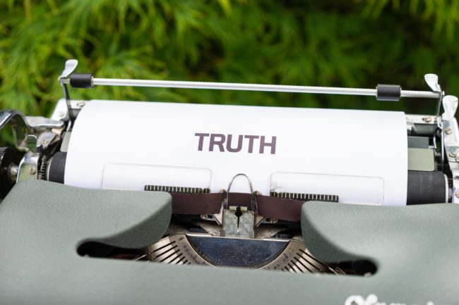 Paper in typewriter that reads TRUTH