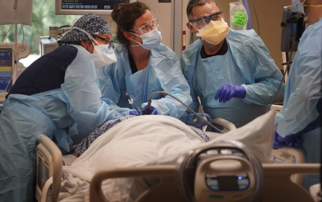 Medical workers at Morton Plant Hospital in Clearwater, Fla., work to stabilize a COVID-19 patient in late August, 2021.